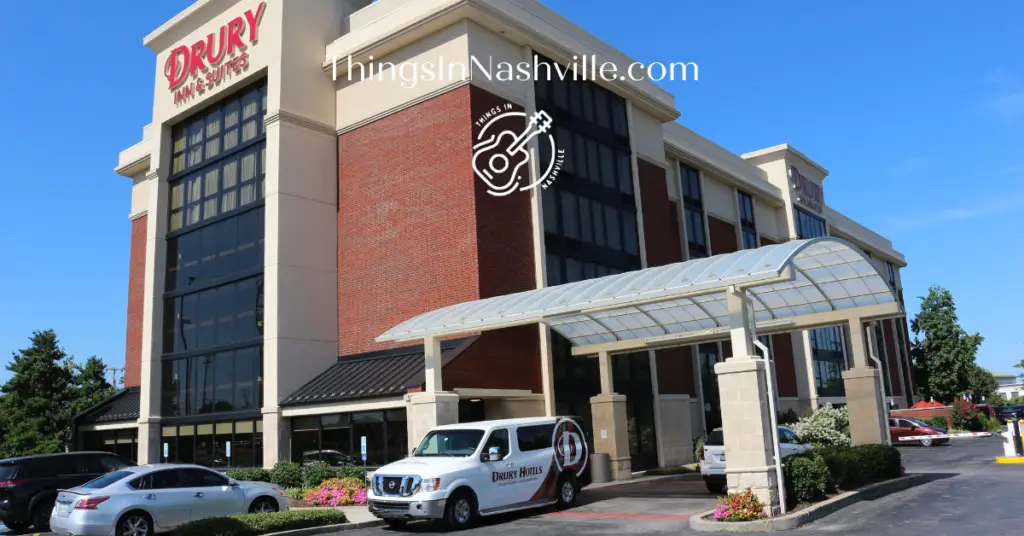 Drury Inn and Suites located near the Nashville airport with hotel shuttle parked by the entrance.